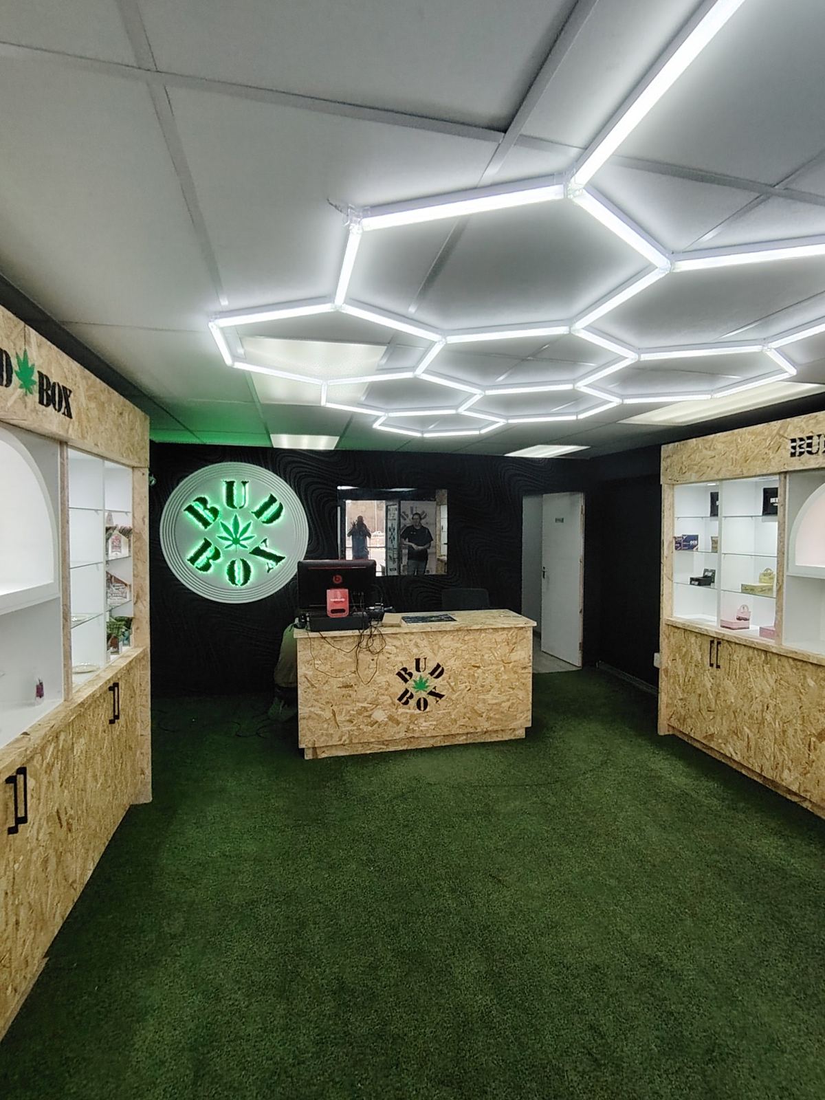 Bud Box club with the round halo sign, OSB counter and display walls